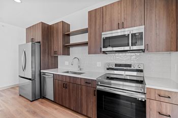 a kitchen with stainless steel appliances and wooden cabinets